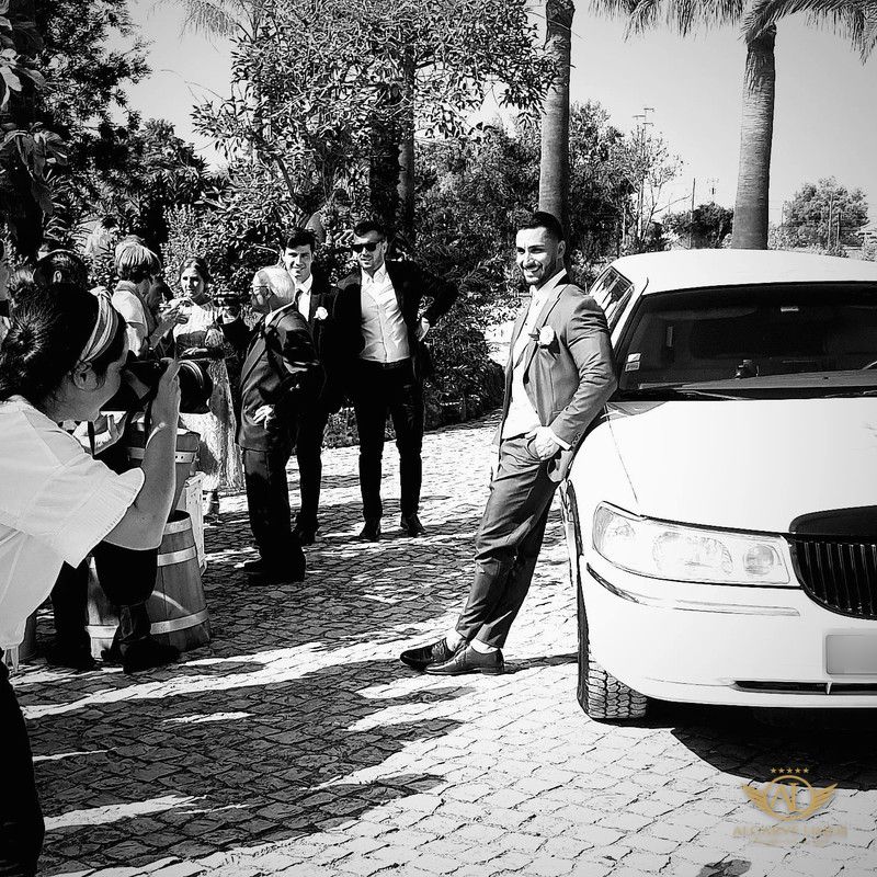 Groom beside the Algarve Limos stretch limousine on his wedding day